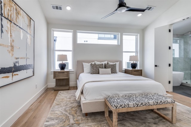 bedroom with light wood-type flooring, baseboards, and visible vents