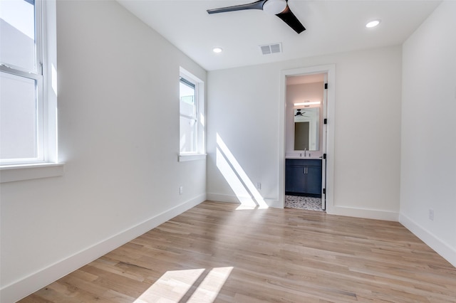 empty room with recessed lighting, visible vents, light wood-style flooring, a ceiling fan, and baseboards