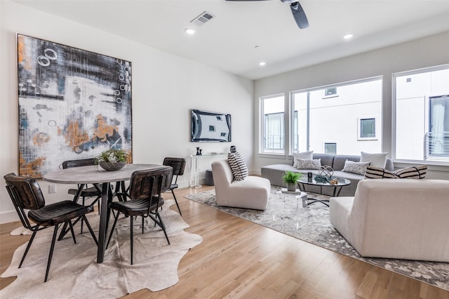 living area featuring a ceiling fan, recessed lighting, visible vents, and light wood finished floors