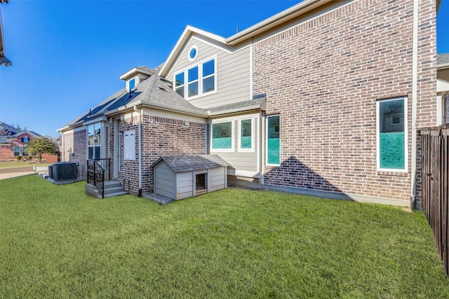 513 Yarrow St, Little Elm, TX 75068 - back of property with brick siding, central AC, a yard, and a shed