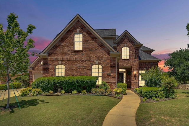 1661 Terrace Dr, Lantana, TX 76226 - traditional home with brick siding, a yard, roof with shingles, and an attached garage