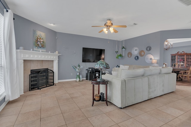 1661 Terrace Dr, Lantana, TX 76226 - tiled living room featuring ceiling fan, a chandelier, a fireplace, and baseboards