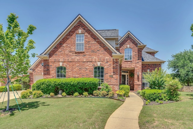1661 Terrace Dr, Lantana, TX 76226 - traditional home featuring brick siding, a front yard, and a shingled roof