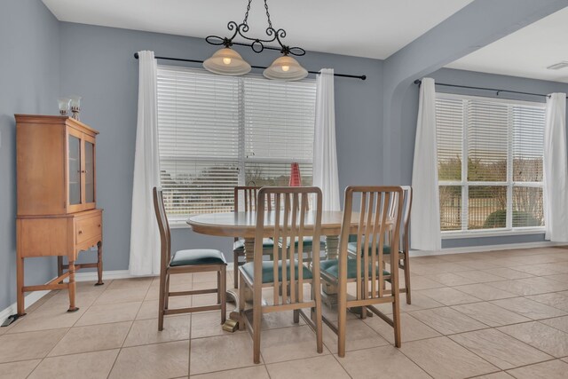 dining room featuring light tile patterned floors, baseboards, and visible vents