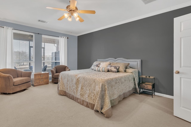 carpeted bedroom with visible vents, baseboards, crown molding, and a ceiling fan