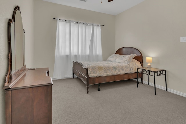 bedroom featuring light carpet, ceiling fan, and baseboards