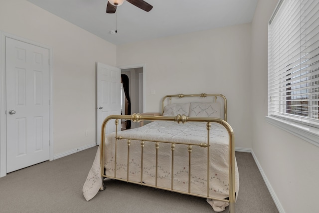 carpeted bedroom featuring ceiling fan and baseboards