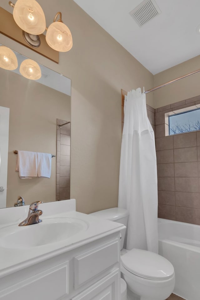 full bath featuring toilet, vanity, shower / bath combo with shower curtain, and visible vents