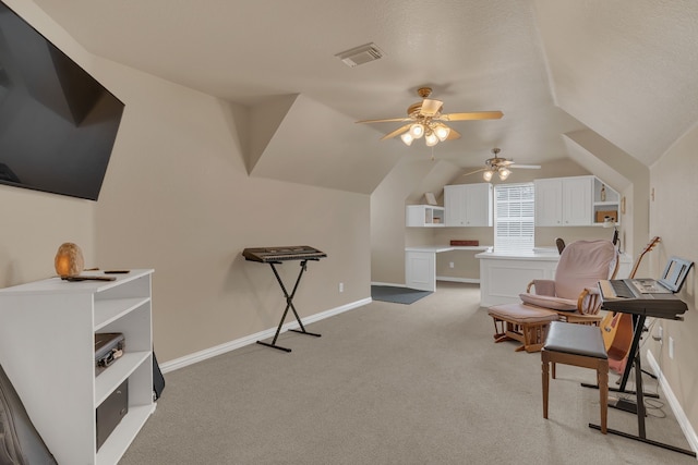 living area with visible vents, baseboards, ceiling fan, vaulted ceiling, and light colored carpet