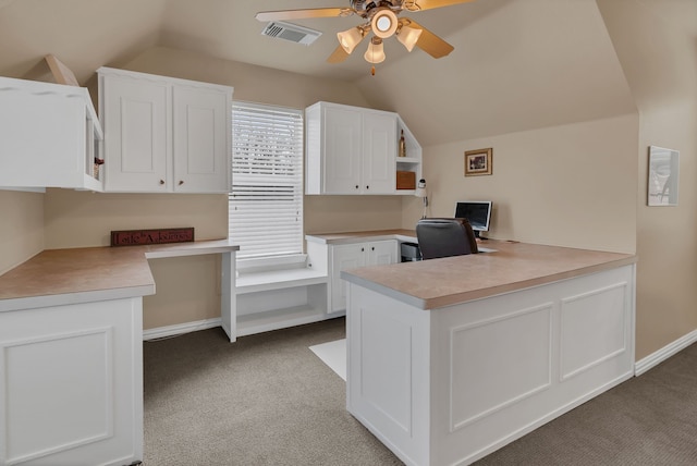 home office with visible vents, ceiling fan, carpet, and lofted ceiling