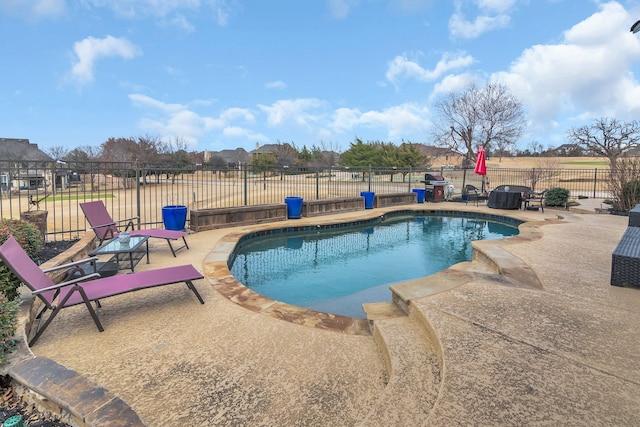 view of pool featuring a patio area, a fenced in pool, and fence