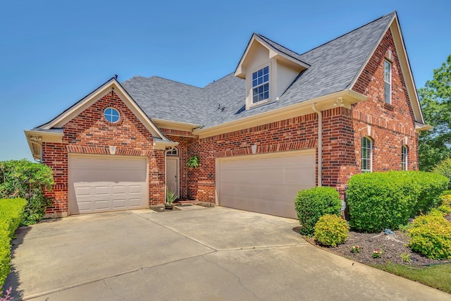 1661 Terrace Dr, Lantana, TX 76226 - view of front of house featuring brick siding, a shingled roof, driveway, and an attached garage