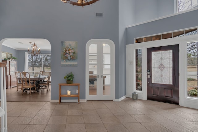 1661 Terrace Dr, Lantana, TX 76226 - entryway with a chandelier, arched walkways, healthy amount of natural light, and a towering ceiling