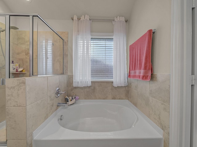 full bath with a shower stall and a garden tub