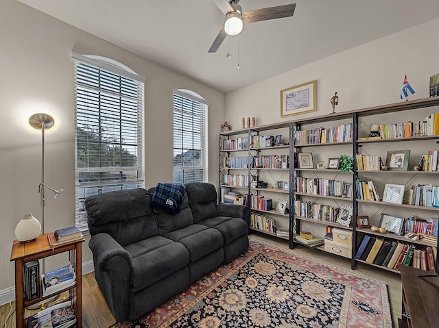 living area featuring wood finished floors and a ceiling fan