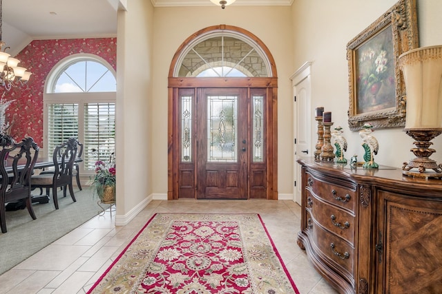 foyer entrance featuring light carpet, light tile patterned floors, baseboards, and a chandelier