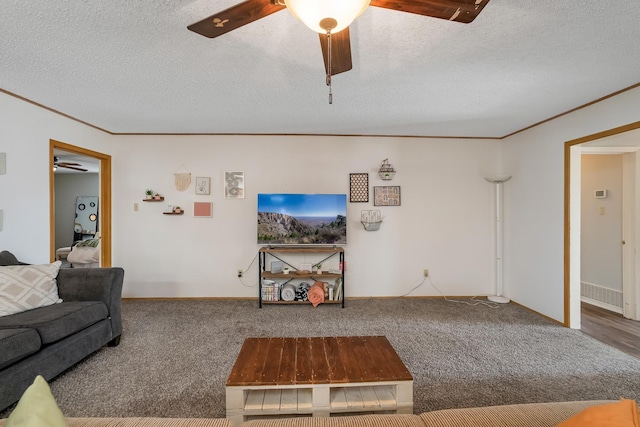 living area featuring carpet floors, crown molding, a textured ceiling, and a ceiling fan