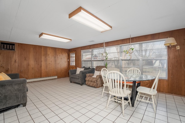 dining area with light tile patterned floors, an AC wall unit, wood walls, and a baseboard radiator