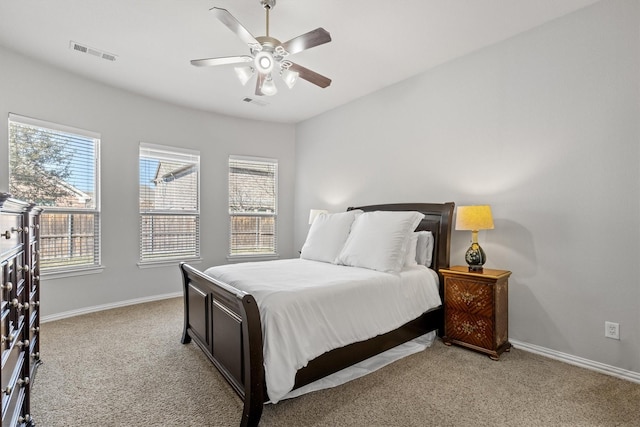 bedroom featuring baseboards, visible vents, ceiling fan, and light colored carpet