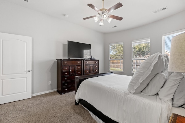 bedroom featuring carpet floors, a ceiling fan, visible vents, and baseboards