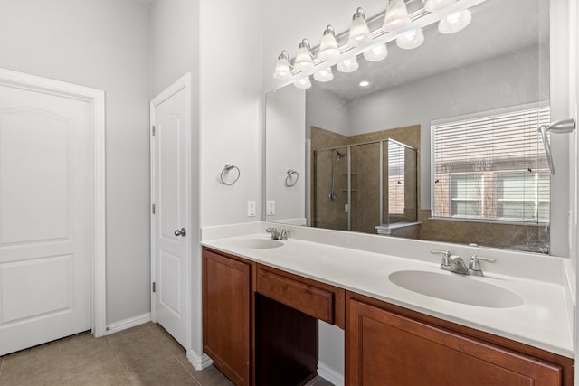 full bath featuring double vanity, a stall shower, tile patterned flooring, and a sink