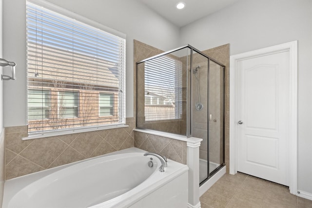 bathroom featuring a shower stall, a bath, and tile patterned floors