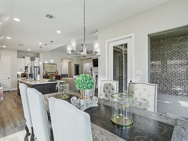 dining space with visible vents, a chandelier, dark wood-style flooring, and recessed lighting