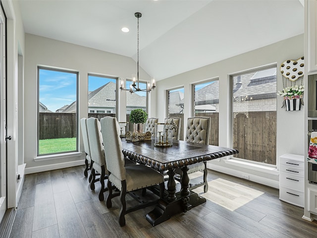 dining room with lofted ceiling, baseboards, dark wood-style floors, and a chandelier