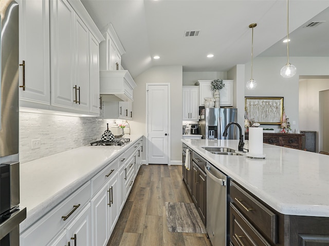 kitchen with appliances with stainless steel finishes, white cabinets, visible vents, and dark brown cabinetry