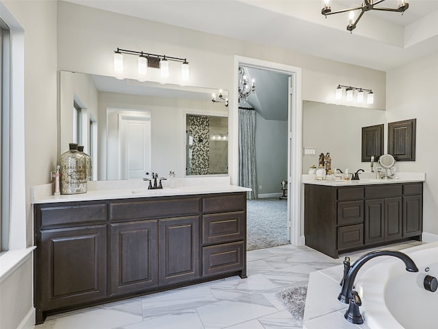 bathroom with an inviting chandelier, two vanities, a sink, and tiled shower