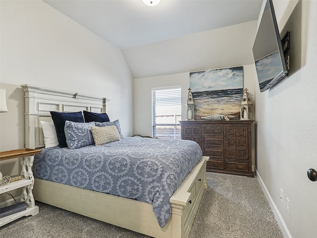 bedroom with carpet floors, baseboards, and vaulted ceiling