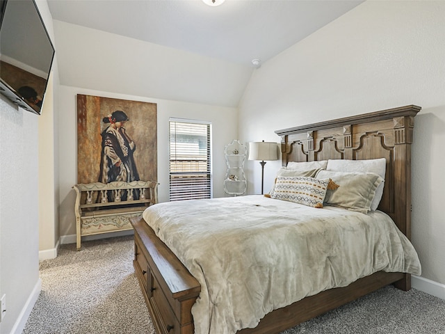 bedroom with carpet flooring, vaulted ceiling, and baseboards