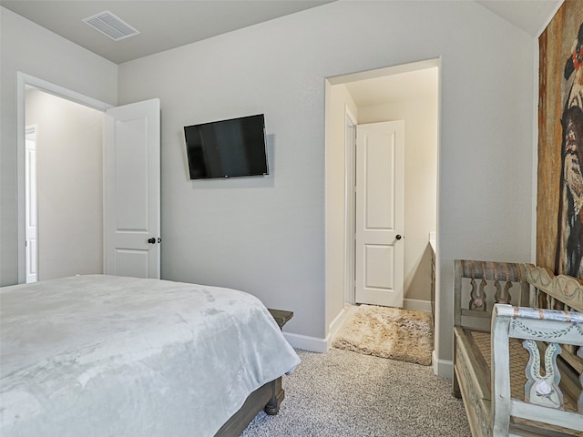 carpeted bedroom featuring visible vents and baseboards