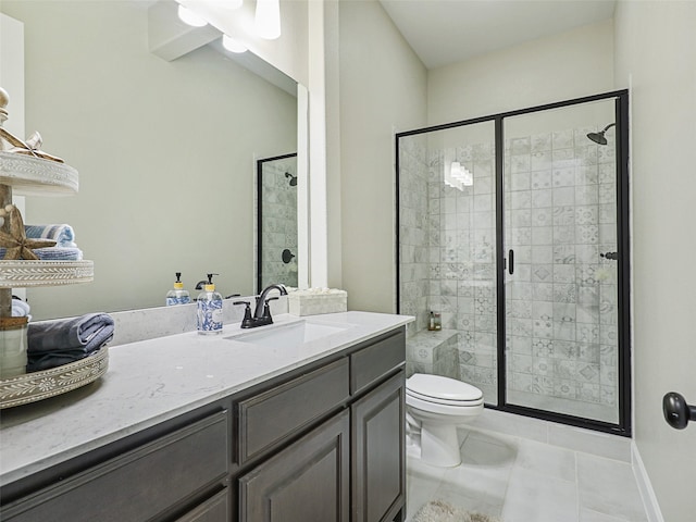 full bathroom featuring a stall shower, tile patterned flooring, vanity, and toilet