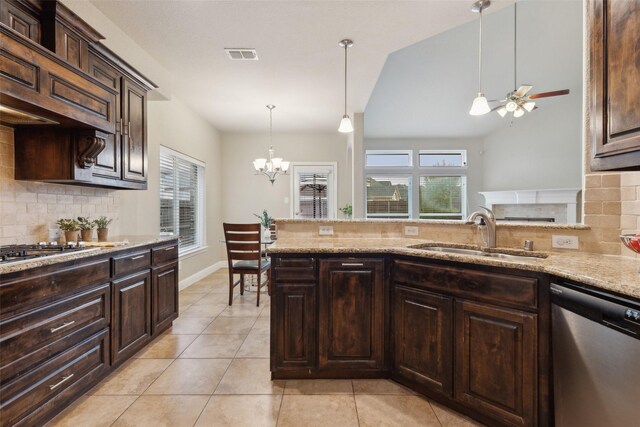 kitchen featuring dark brown cabinetry, decorative backsplash, appliances with stainless steel finishes, light stone countertops, and pendant lighting