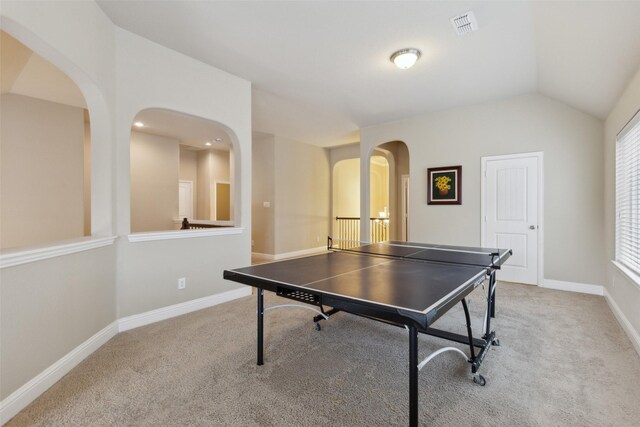 recreation room with light carpet, visible vents, and lofted ceiling