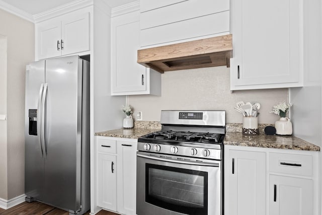 kitchen featuring custom exhaust hood, appliances with stainless steel finishes, stone countertops, ornamental molding, and white cabinets