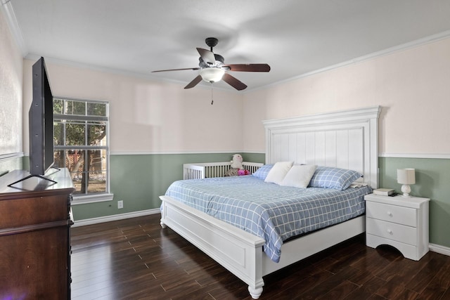 bedroom featuring baseboards, wood finished floors, a ceiling fan, and crown molding