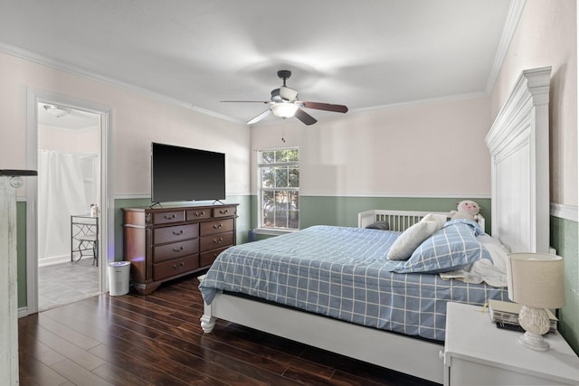 bedroom with ornamental molding, wainscoting, dark wood finished floors, and a ceiling fan