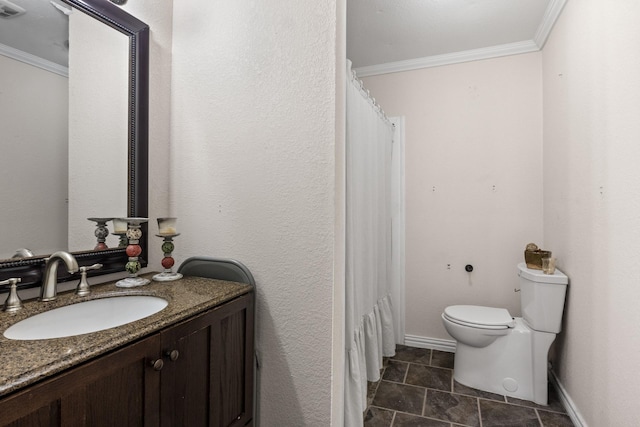 bathroom featuring baseboards, vanity, toilet, and crown molding