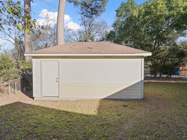 view of shed featuring fence