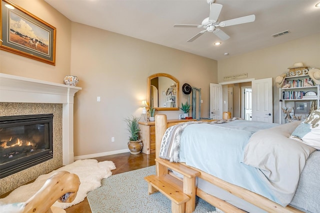 bedroom with baseboards, visible vents, ceiling fan, a premium fireplace, and recessed lighting