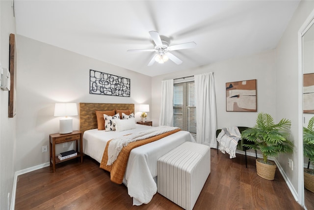 bedroom with ceiling fan, baseboards, and dark wood finished floors