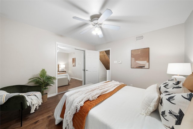 bedroom featuring visible vents, ceiling fan, baseboards, and wood finished floors