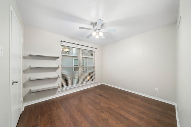 empty room featuring ceiling fan, wood finished floors, and baseboards