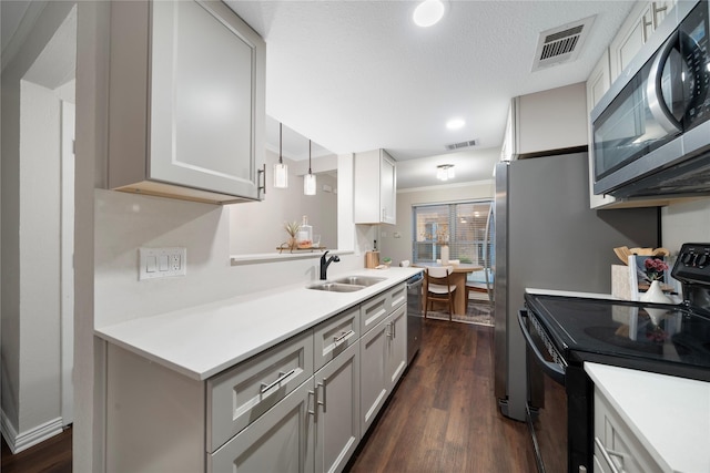 kitchen with visible vents, stainless steel appliances, a sink, and light countertops