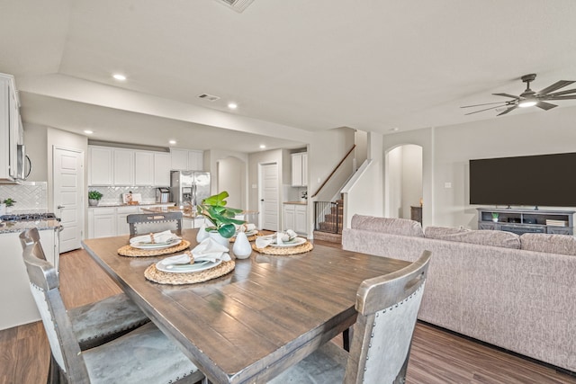 4137 Agatha Ln, Celina, TX 76227 - dining area featuring arched walkways, wood finished floors, stairway, a ceiling fan, and recessed lighting