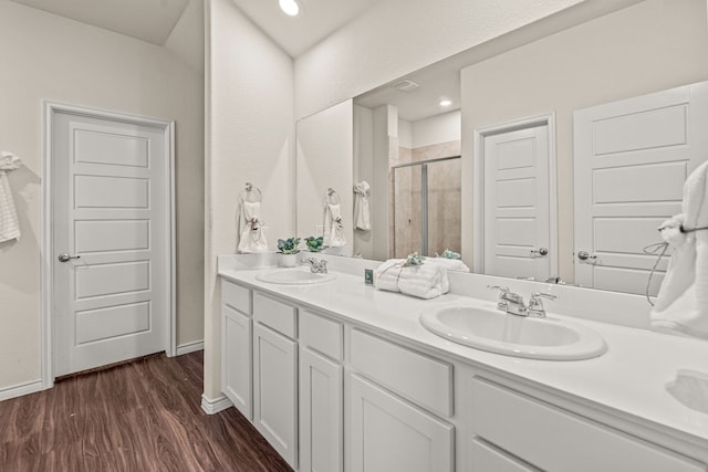 4137 Agatha Ln, Celina, TX 76227 - bathroom featuring a stall shower, double vanity, wood finished floors, and baseboards