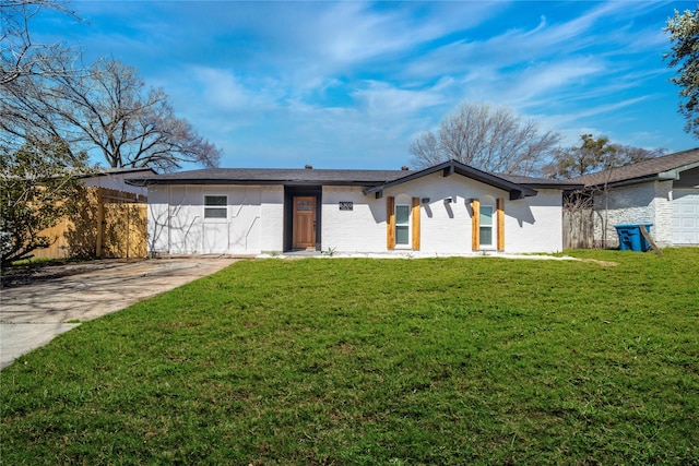 ranch-style house with brick siding, a front yard, and fence