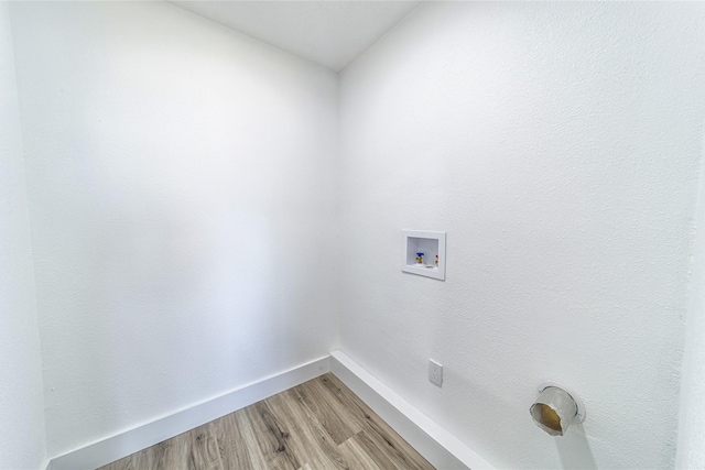laundry room featuring hookup for a washing machine, light wood-style flooring, and baseboards